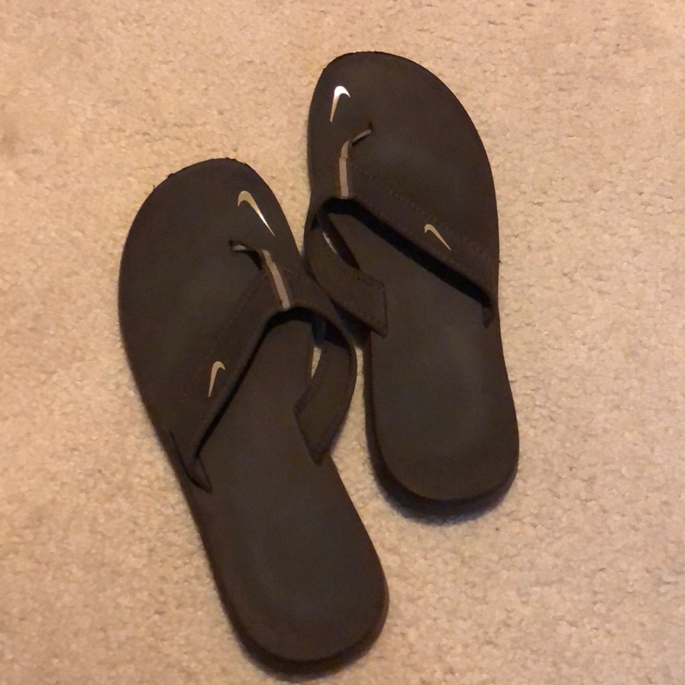 Brown Nike flip flops